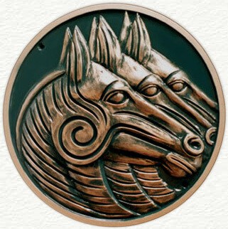 Circular sculptured plaque of horses heads