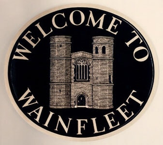 Wainfleet town sign with the historic magdalen school