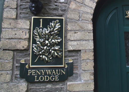 Double sided swinging house sign