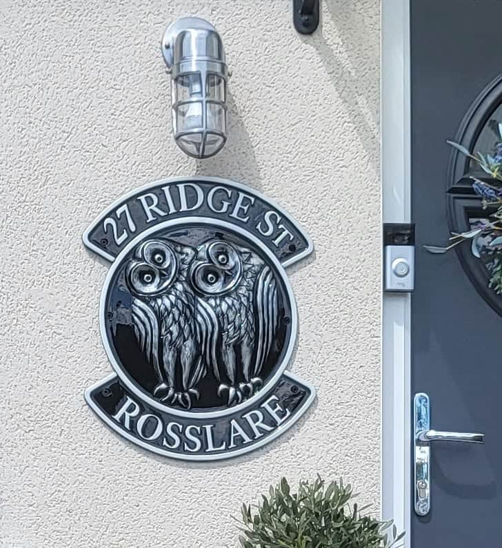 Large house sign of two little owls