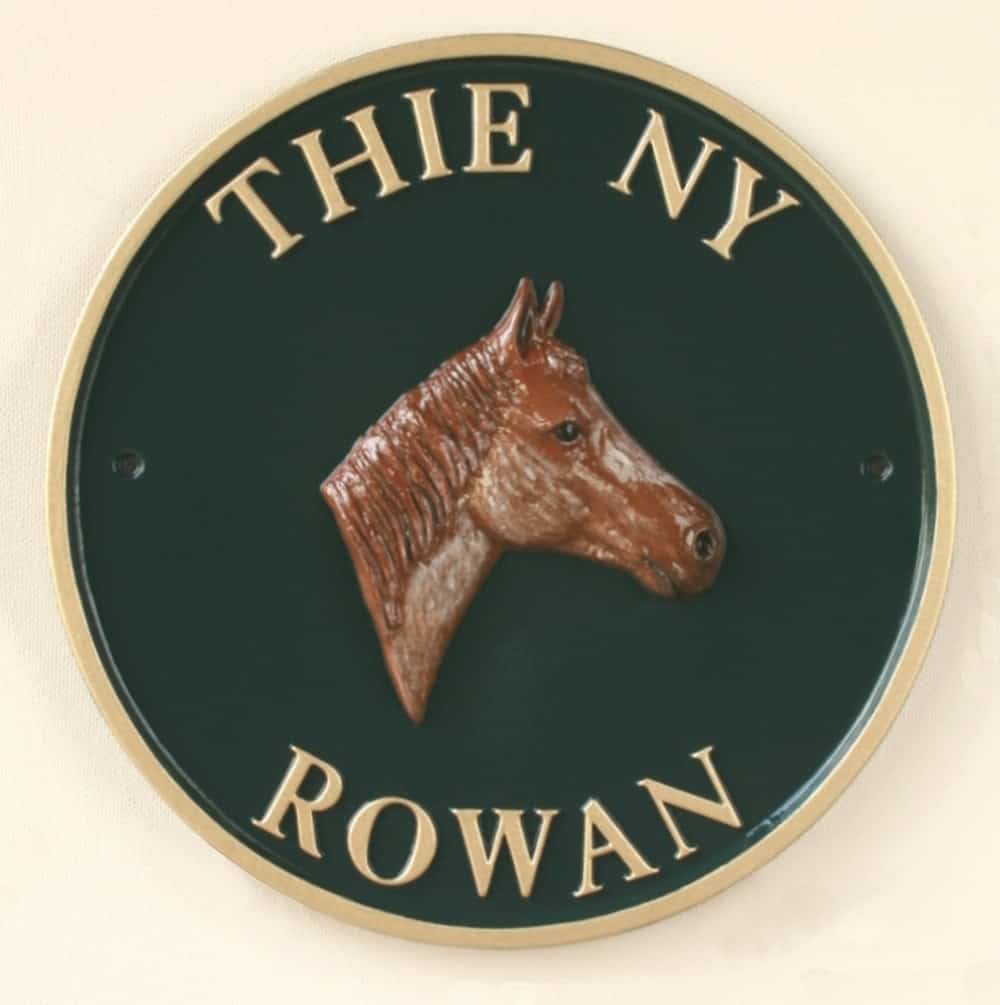 circular metal stable sign with horse motif